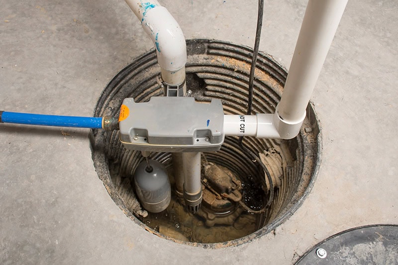 Pipes going into the floor of basement.