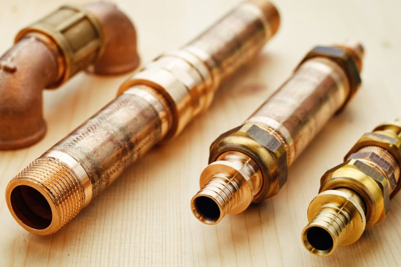 How Often Do I Need Plumbing Maintenance? Plumbing tools on a light woody background.